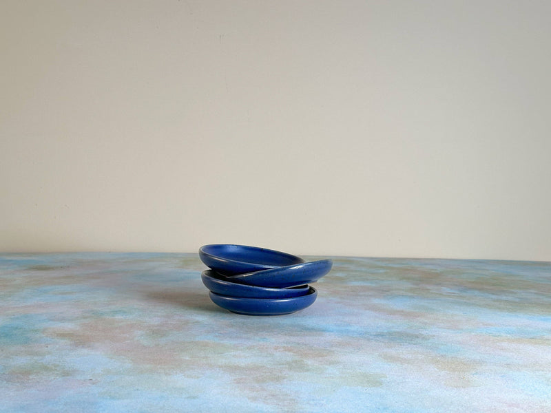 Sarah Kersten - Olive Dish: Basin Collection, a stack of elegant, small ceramic blue bowls on a table, ideal for versatile kitchen use.
