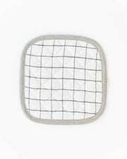 MagicLinen - Linen pot-holder: A white and black plaid, square-shaped pot holder with quilted detailing and a hanging loop, perfect for kitchen heat protection.