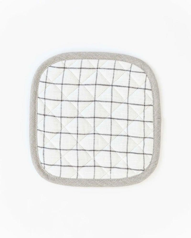 MagicLinen - Linen pot-holder: A white and black plaid, square-shaped pot holder with quilted detailing and a hanging loop, perfect for kitchen heat protection.