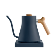 Fellow | Stagg EKG Electric Kettle with matte navy body and wood accents, on base. Ideal for precision pour-over coffee or tea brewing.