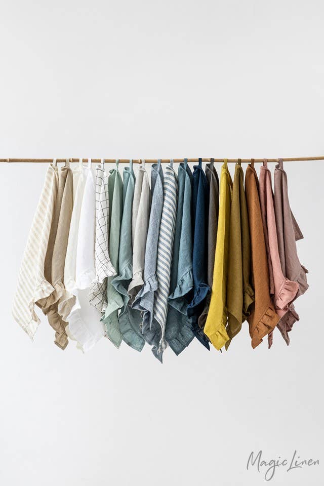 MagicLinen - Ruffle trim tea towel hanging, showcasing its linen texture and practical loop for easy kitchen use.