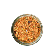 San Juan Island Sea Salt - Friday Harbor Seafood Seasoning Blend in a glass jar, a coarse reddish-orange mix of spices ideal for enhancing seafood dishes.