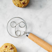 King Arthur Baking Company | Baker's Batter Whisk with triple-loop design beside a muffin, showcasing its efficient mixing capability for various batters.