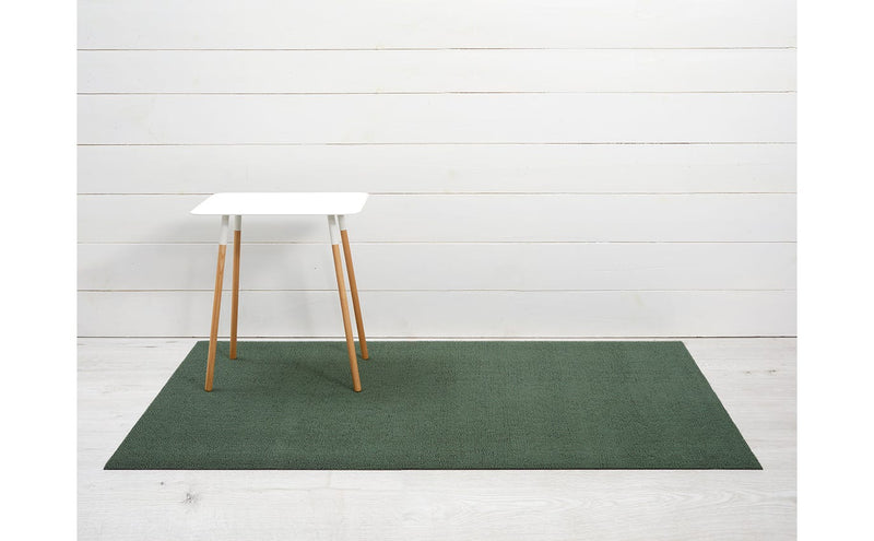 Chilewich Solid Shag Mats - Cactus - 24 x 36 displayed on a green rug, showcasing its modern design and durable texture, ideal for versatile indoor or outdoor use.