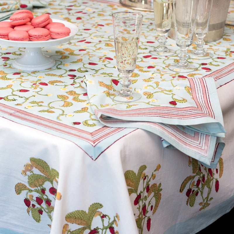 Caravan Home Fraises des Bois Blue Napkins, set of 6, showcased with cookies and glassware on a table, highlighting vibrant countryside-inspired design.
