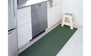 Chilewich Solid Shag Mat in Cactus, 24x36, displayed in a kitchen setting, highlighting its versatile design suitable for high-traffic indoor areas.