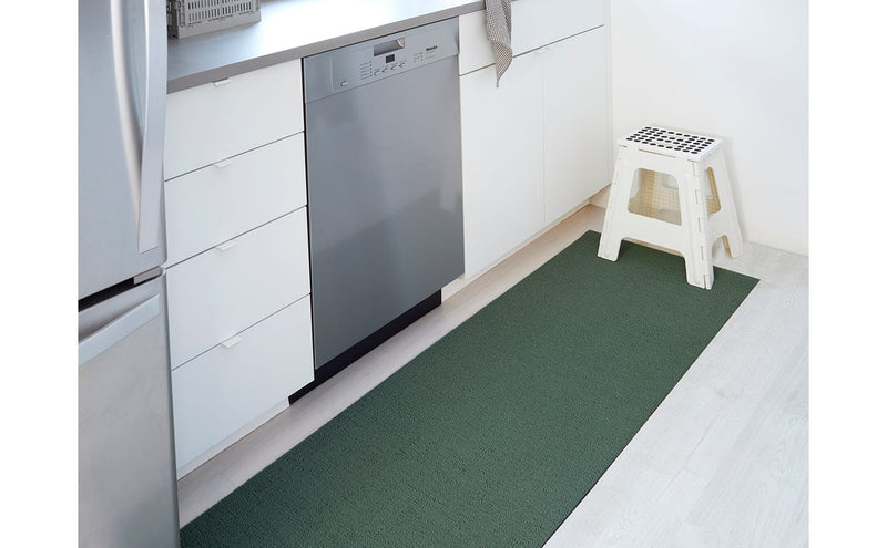 Chilewich Solid Shag Mat in Cactus, 24x36, displayed in a kitchen setting, highlighting its versatile design suitable for high-traffic indoor areas.