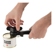 Hands using Kuhn Rikon | LidLifter, Black, effortlessly open a metal can, showcasing its ergonomic design and self-attaching feature for safe, clean, and easy can opening.