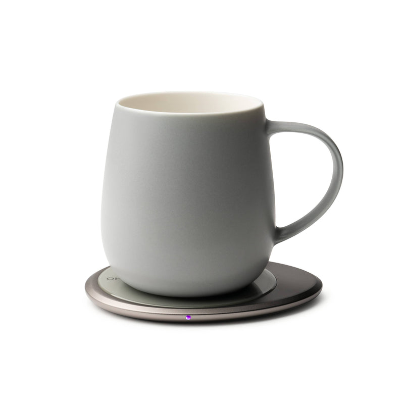 OHOM - Ui 3 Self-heating Mug Set: Soft Gray on a metallic base, designed to maintain beverage warmth and wirelessly charge devices, reflecting modern functionality.