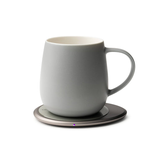 OHOM - Ui 3 Self-heating Mug Set: Soft Gray on a metallic base, designed to maintain beverage warmth and wirelessly charge devices, reflecting modern functionality.