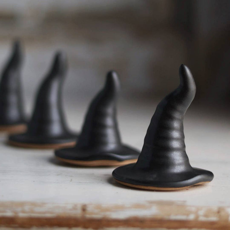Gravesco Pottery - Black Witch Hat: Handmade ceramic ring holder or decor resembling edible witch hat cookies, perfect for Halloween-themed kitchen displays or gifts.
