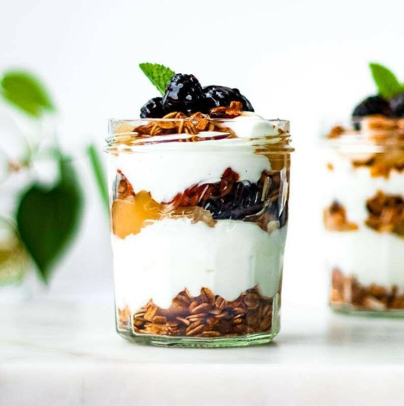 Le Parfait | Faceted French Jam Jar, 385ml, filled with layered yogurt parfait, crunchy granola, fruit compote, fresh blackberries, and a mint leaf garnish.