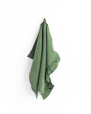 MagicLinen - Ruffle trim linen tea towel hanging, showcasing its soft, absorbent fabric and elegant design, ideal for stylish kitchen use.