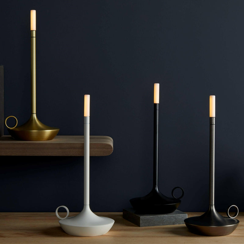 VANMOKUM | GRAYPANTS Wick Portable Rechargeable Lamp displayed among elegant candlesticks, highlighting its versatile design for intimate or bustling settings.