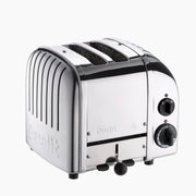 Dualit | 2 Slice Classic Toaster, Polished: A four-slot chrome toaster with control knobs and lever, embossed brand name, showcasing durability and energy-saving features.