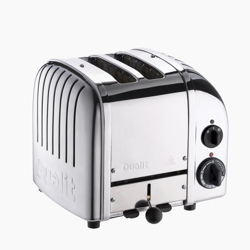 Dualit | 2 Slice Classic Toaster, Polished: A four-slot chrome toaster with control knobs and lever, embossed brand name, showcasing durability and energy-saving features.