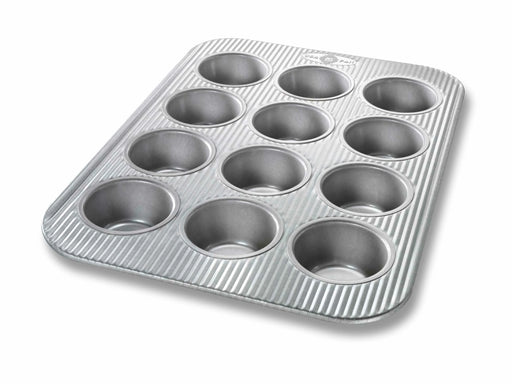 USA Pan | Muffin Pans - 12 Cup Muffin Pan & Lid Set, featuring twelve metal cups for baking muffins or cupcakes, with a durable, nonstick surface.