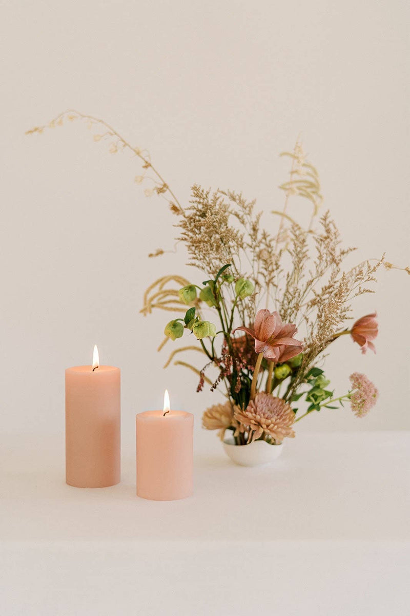 Mo&Co Home - 100% Beeswax Pillar Candles | Rose Pink: 3x6 Inch, with a vase of flowers, ideal for elegant home settings and celebrations.