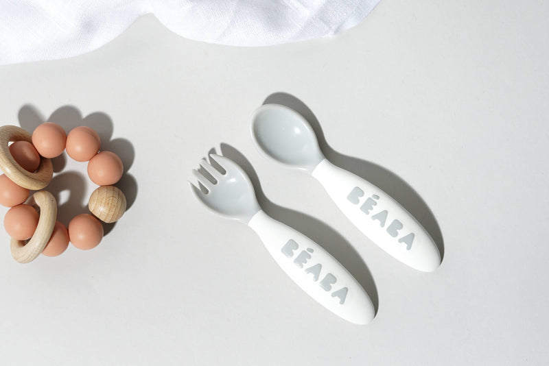BEABA & Childhome | BEABA Toddler's Self-Feeding Cutlery - Breeze set, featuring close-ups of spoon, wooden ball, and egg, emphasizing ergonomic design for self-feeding toddlers.