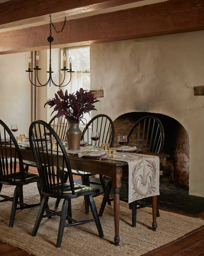 Wheat Harvest Dinner Napkin on a rustic table with candles, wine glasses, and a floral centerpiece, embodying fall abundance in a cozy dining setting.
