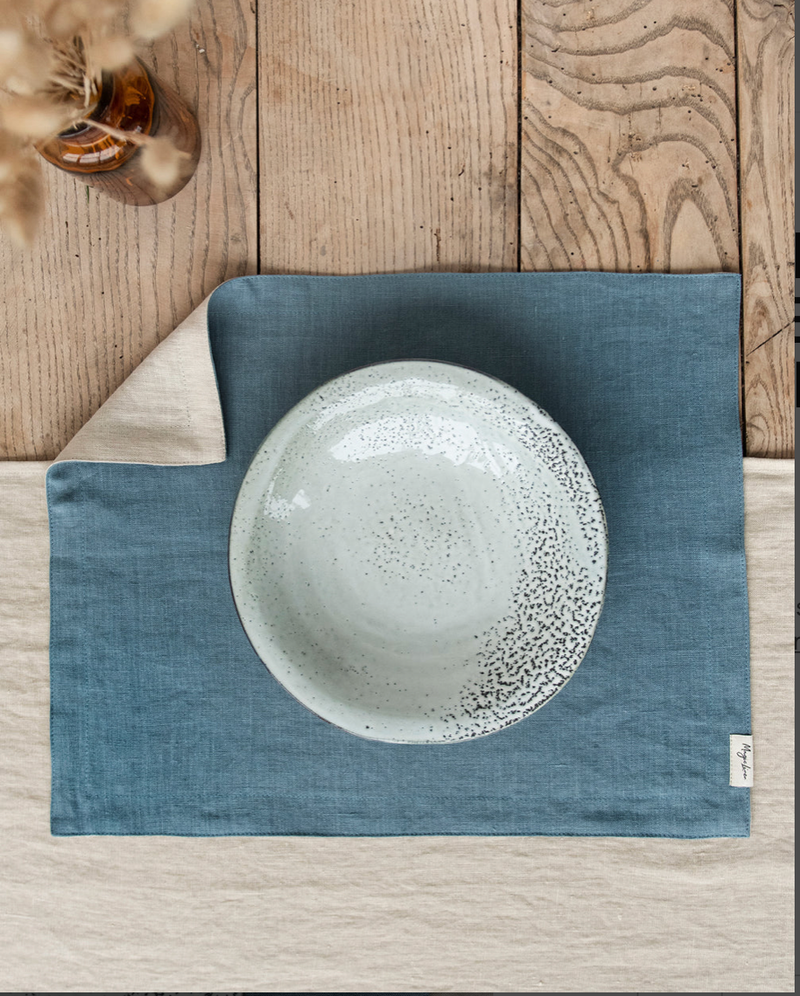 MagicLinen - Double Layer Linen Placemat Set of 2: Latte, displayed on a wooden surface with a white ceramic plate, showcasing its soft, elegant texture.