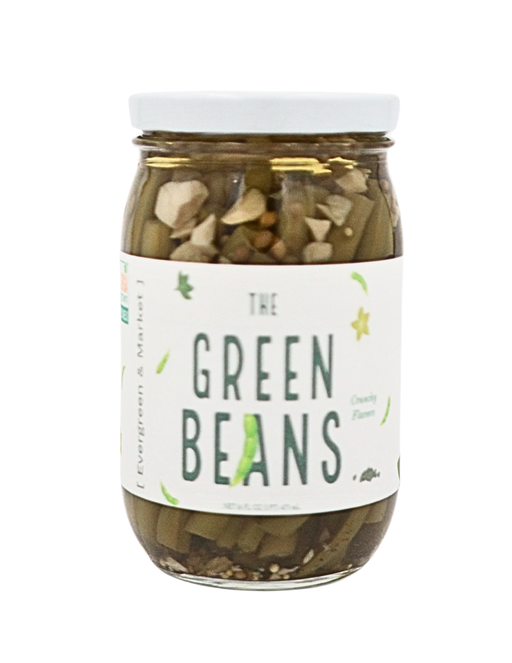 [PICKLES] by Evergreen and Market - The Spicy Beans; clear glass jar with pickled green beans, sliced garlic, and peppercorns in brine, ideal for culinary enhancement.