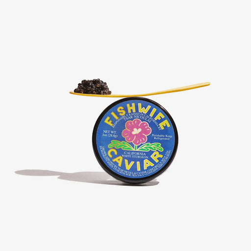 Fishwife - PREORDER: Caviar - 1oz tin with mother-of-pearl spoon holding black caviar, showcasing a luxurious, creamy, and nutty delicacy from eco-certified California sturgeon.