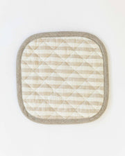 Close-up of a MagicLinen linen pot-holder with quilted detailing and a hanging loop, ideal for kitchen use, available in various colors.