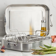 Hestan Provisions | Classic Roaster with Rack, 14.5 Inches, displayed with olive oil, asparagus, fig, and garlic, highlighting its robust stainless-steel construction and versatility.