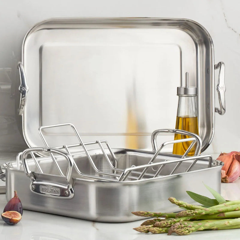 Hestan Provisions | Classic Roaster with Rack, 14.5 Inches, displayed with olive oil, asparagus, fig, and garlic, highlighting its robust stainless-steel construction and versatility.