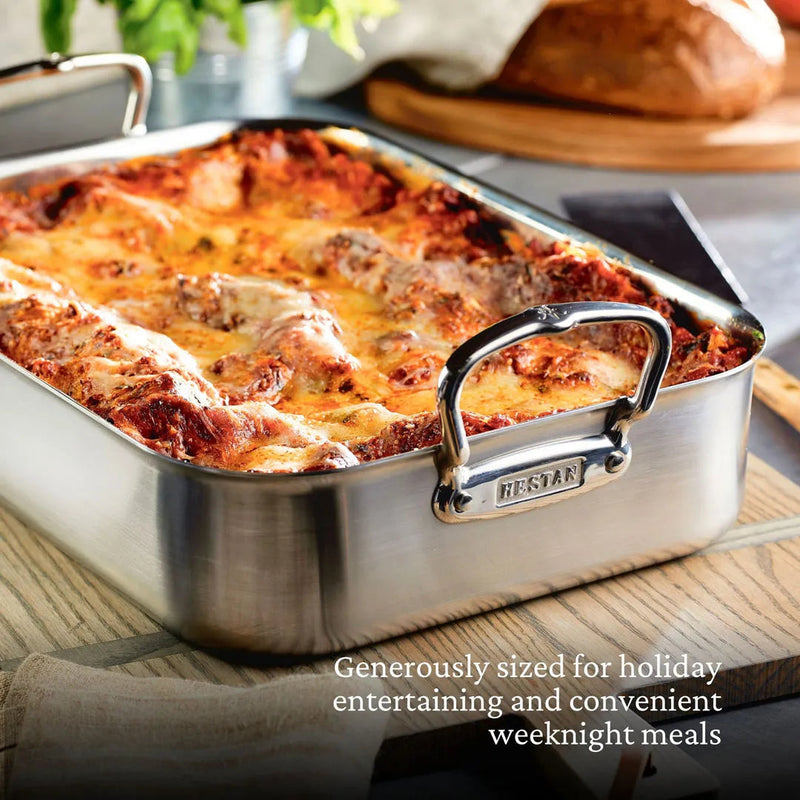 Hestan Provisions | Classic Roaster with Rack, 14.5 Inches, showcasing a bubbling lasagna, ideal for holiday meals and everyday cooking, on a wooden board.