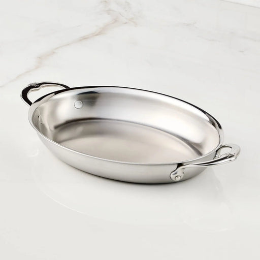 Hestan Provisions | Medium Clad Oval Au Gratin, a polished stainless-steel roasting pan with handles, exemplifying elegance and craftsmanship for discerning chefs and home cooks.