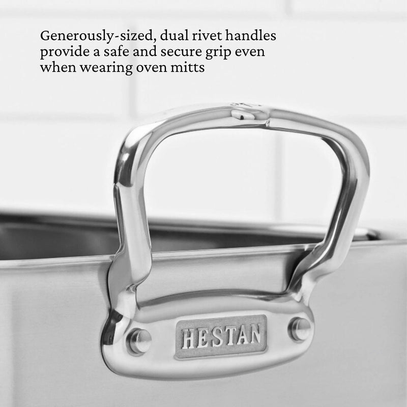 Close-up of Hestan | Polished Clad Stainless Steel Roaster with Rack, Small, showcasing its sturdy dual rivet handle, emphasizing safety and ergonomic design for secure grip.