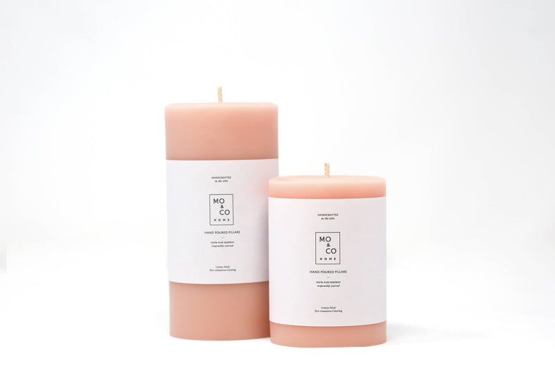 Mo&Co Home - 100% Beeswax Pillar Candles | Rose Pink: Two pink candles with white labels, hand-poured from pure beeswax for eco-friendly burning.