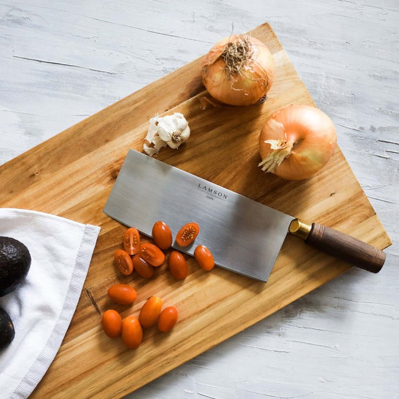 Lamson 8 Chinese Vegetable Cleaver with Walnut Handle on a cutting board surrounded by various vegetables, highlighting its use in kitchen prep.