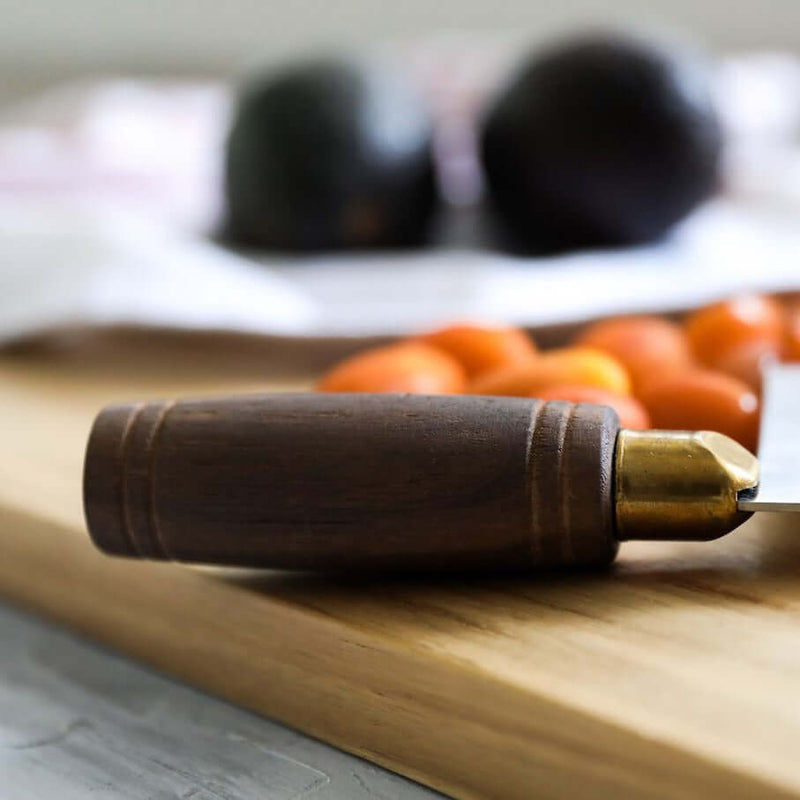 Lamson 8 Chinese Vegetable Cleaver with Walnut Handle on a cutting board, showcasing its craftsmanship and design for precision in kitchen tasks.