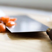 Lamson 8 Chinese Vegetable Cleaver with Walnut Handle and Leather Sheath on wooden surface alongside tomatoes.