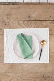 MagicLinen - Set of 2 linen napkins on a table with a spoon and napkin, showcasing versatile table decor for elegant dining.