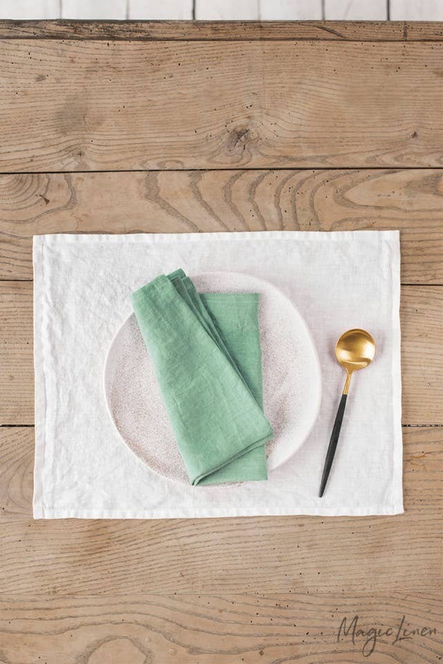 Set of 2 linen napkins on a table with a spoon, showcasing MagicLinen's versatile table decor, ideal for enhancing any dining setting.
