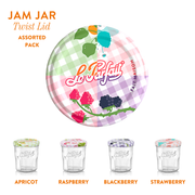Le Parfait | Faceted French Jam Jar set features four glass jars with assorted fruit-illustrated twist lids for apricot, raspberry, blackberry, and strawberry flavors.