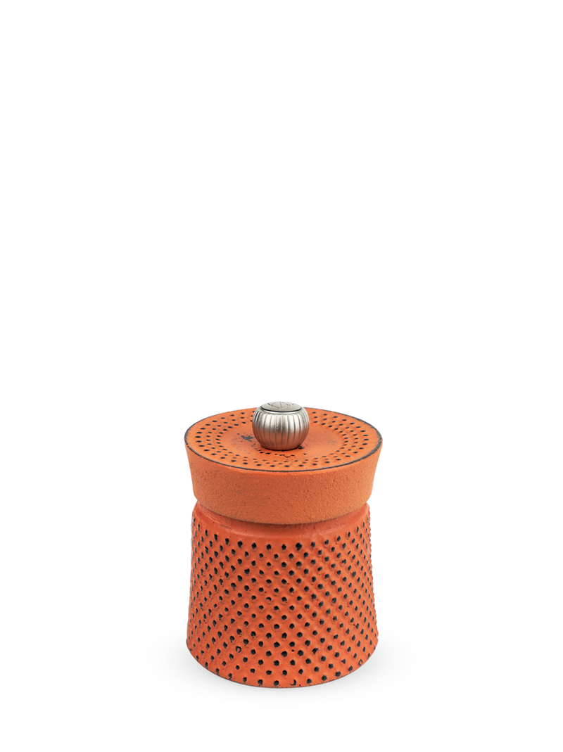 Peugeot | Bali Cast Iron Pepper Mill, Orange: A palm-sized, perforated ceramic mill with a ribbed metal knob, ideal for infusing spices in kitchen rituals.