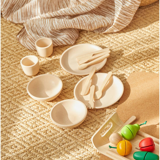 PlanToys | Kids Pretend Playtime Tableware Toy Set displayed on a rug, featuring wooden toy bowls, cups, and cutlery, ideal for imaginative play.
