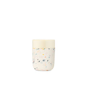 W&P - Reusable Ceramic Mug: Terrazzo Blush / 16 oz with a splash-resistant lid and silicone sleeve for a non-slip grip, perfect for reducing waste.
