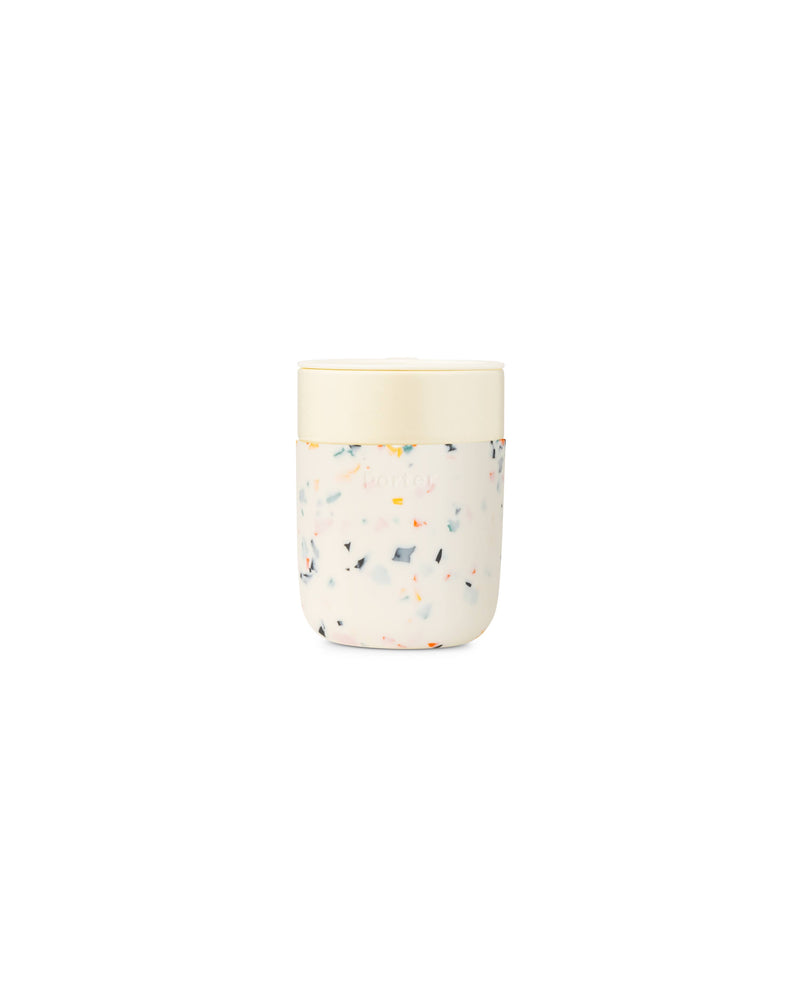 W&P Reusable Ceramic Mug: Terrazzo Charcoal, 16 oz, featuring a white lid and durable ceramic design with a soft-touch silicone sleeve for easy grip.