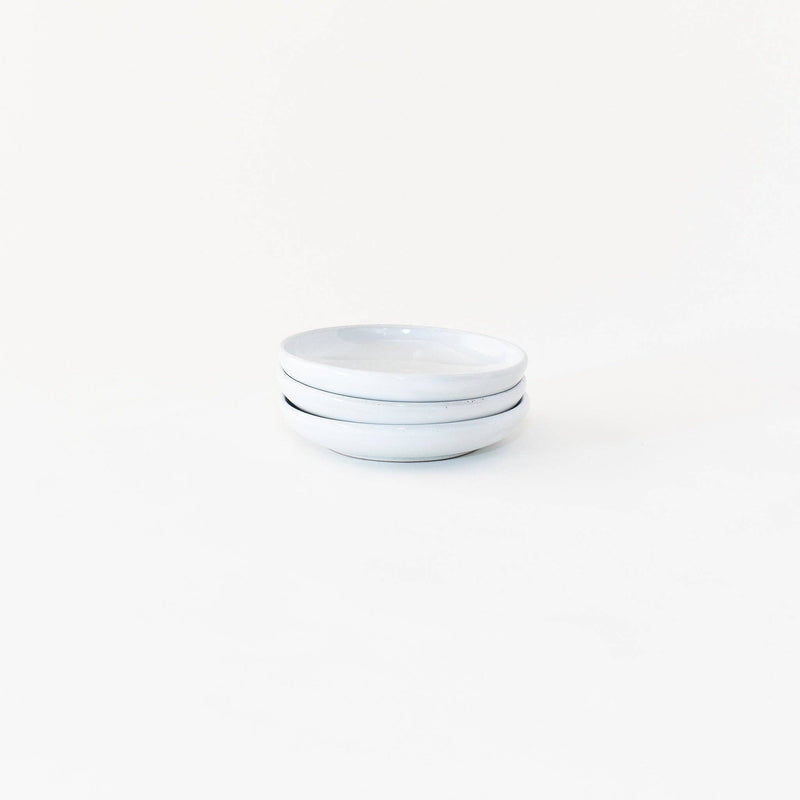 Sarah Kersten - Olive Dish: Basin Collection: Yosemite, showcasing a stack of white plates and bowls, highlighting its versatile design for serving appetizers or sides.