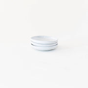 Sarah Kersten - Olive Dish from the Basin Collection, ideal for serving olives or bread, showcased in a stack of elegant white plates and bowls.