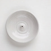 Gravesco Pottery Incense Burner: Off-white ceramic dish with a central spike for incense sticks, designed to catch ash, enhancing any kitchen or living space ambiance.