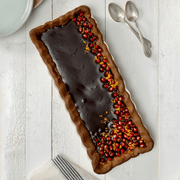 Emile Henry | Deep Flan & Tart Dish, 1.7QT Slim / Cedar, showcased with a chocolate tart garnished with pomegranate arils and citrus zest, highlighting its elegant, practical design.