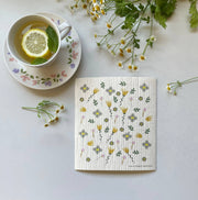 Ink and Fiber Designs - Wildflowers Swedish Dishcloth featuring a cup of tea with lemon and mint, ideal for eco-friendly cleaning tasks in the kitchen.