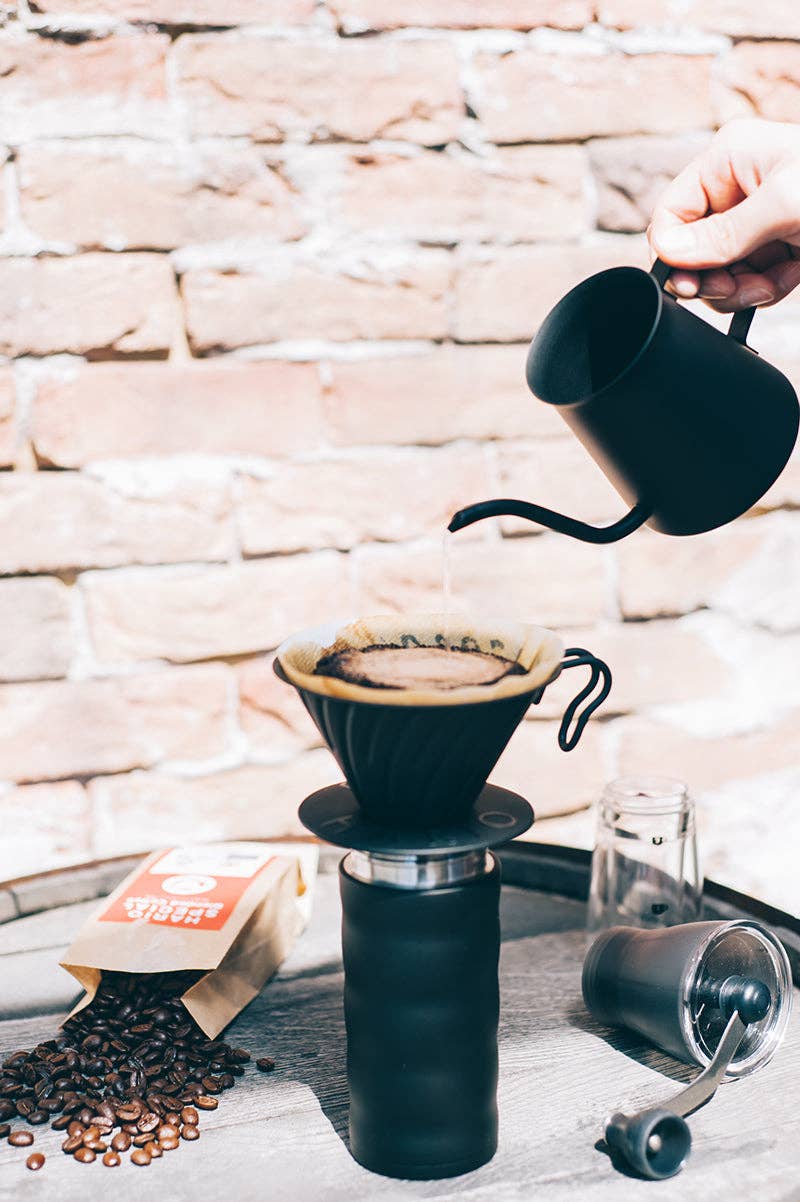 HARIO USA - V60 Metal Dripper: Silver on a pour-over setup, featuring a kettle, coffee grounds, and grinder, epitomizing Athens Cooks' curated kitchen tools.